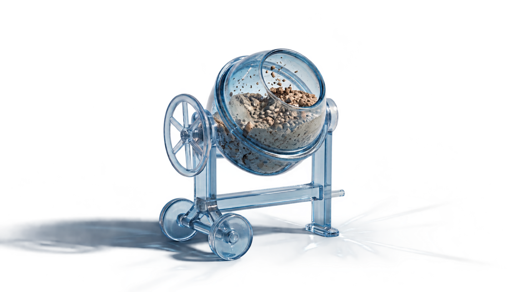 A clear glass concrete mixer containing cement and stone aggregate, with a long cast shadow extending to the left and bright refracted light spreading across the lower-right floor.